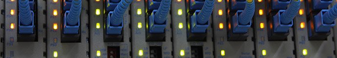 Close up of server rack with CAT5 cables plugged in.